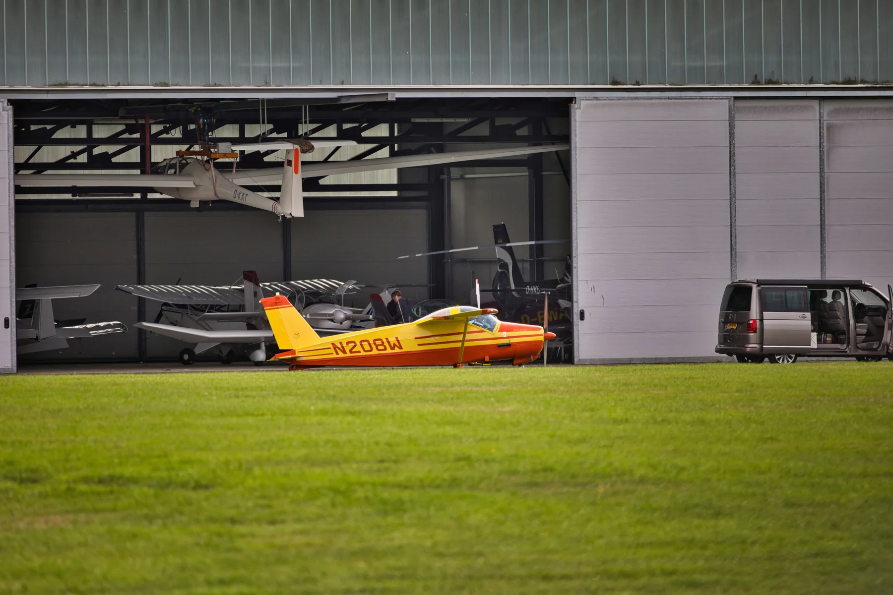 Aircraft parked in a metal aviation hangar