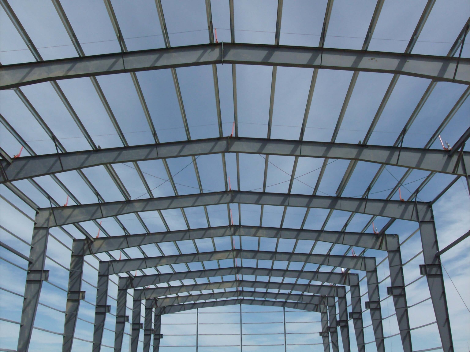 Interior view of structural steel framing inside a metal building